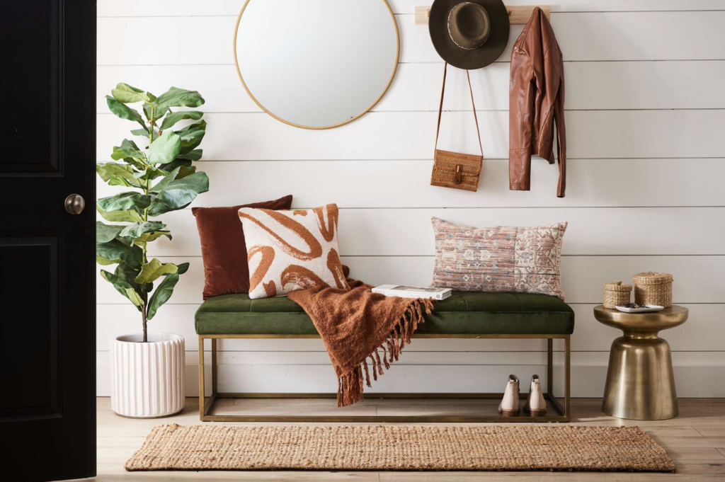 home's front entry with pops of color and green bench